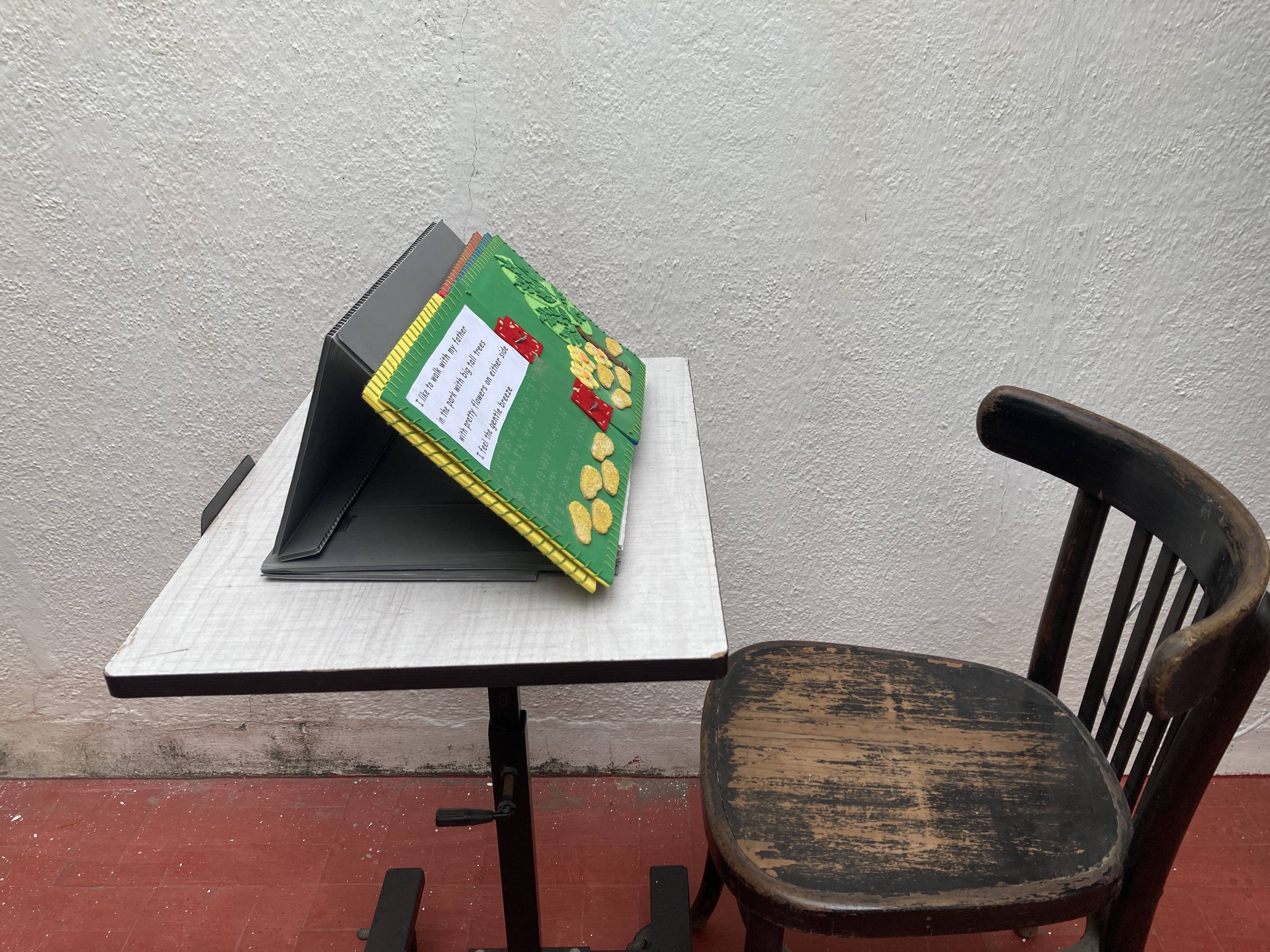 An adjustable slantboard made from carboard to hold a book.